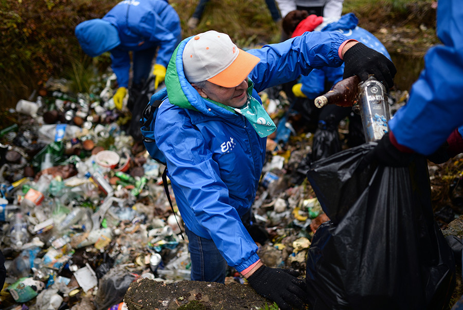 Volunteers collect garbage on the shore of the Lake Baikal at the Murino settlement.