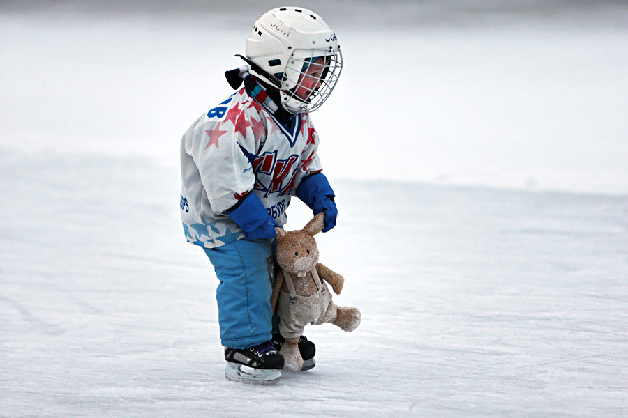 A young boy skating on an outdoor rink in St. Petersburg.