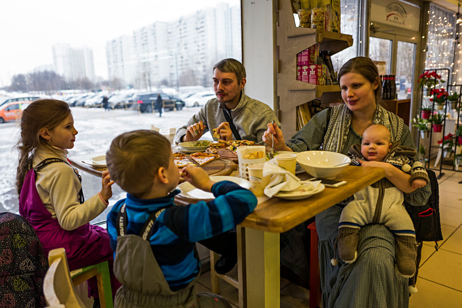 A Moscow's family eats in the cafe.