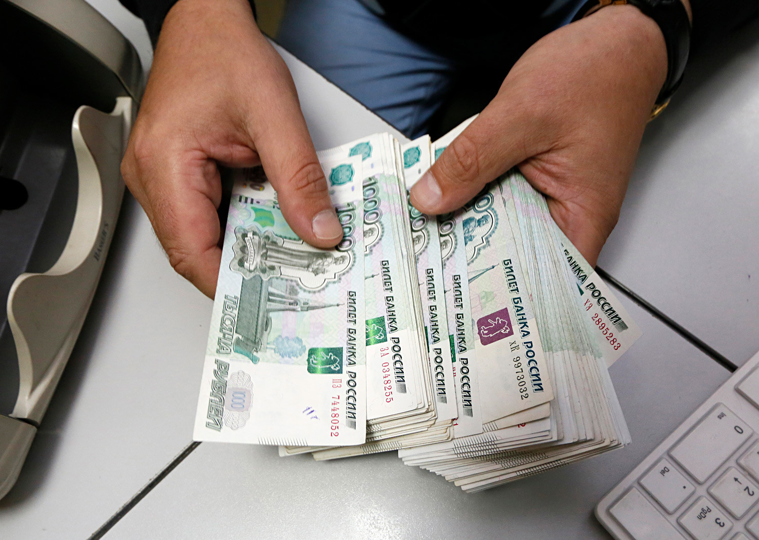 Uslužbenec v nekem podjetju v Krasnojarsku prešteva bankovce. 