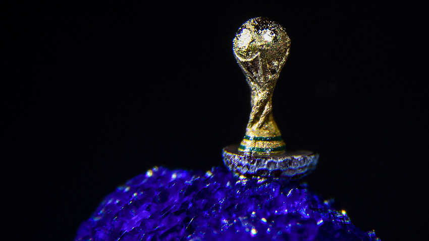 NOVOSIBIRSK, RUSSIA – MAY 11, 2018: A gilded 2018 FIFA World Cup trophy 2mm in height sculpted on a poppy seed by Russian artist Vladimir Aniskin specialising in micro miniature art. 