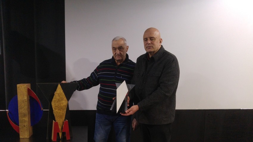 Dmitrij Dragun (Akademija Ciolkovskega) in Dragan Živadinov z maketo prvega umetniškega satelita oz. znakom pokojne igralke Milene Grm.