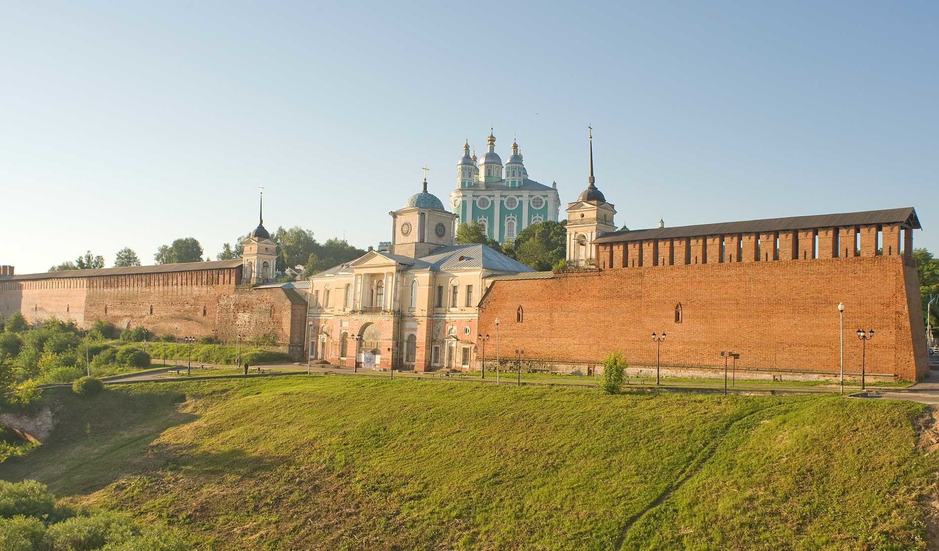 Smolensk citadel. North wall and Gate Church of the Hodegetria Icon of the Virgin. Northwest view from Central Bridge over Dnieper River. July 1, 2014