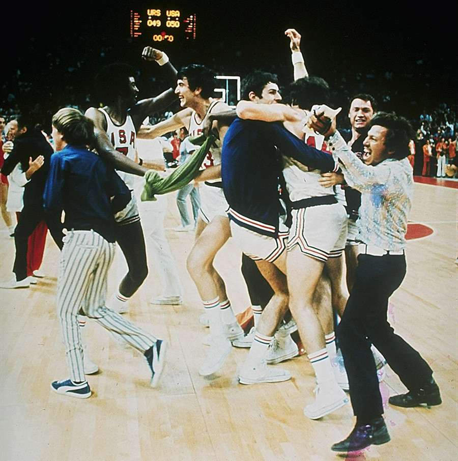 United States basketball team players enjoy a brief moment of elation.