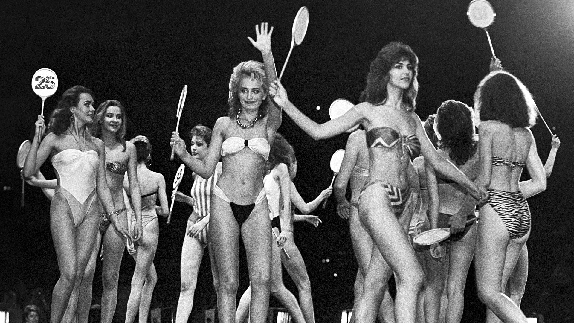 Participants on the runway during swimsuit modeling.