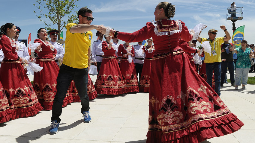 Brazil's fan dance with a woman in traditional dress upon arrival in Rostov-on-Don, Russia, on June 17, 2018. All fans were presented with Cossack caps.