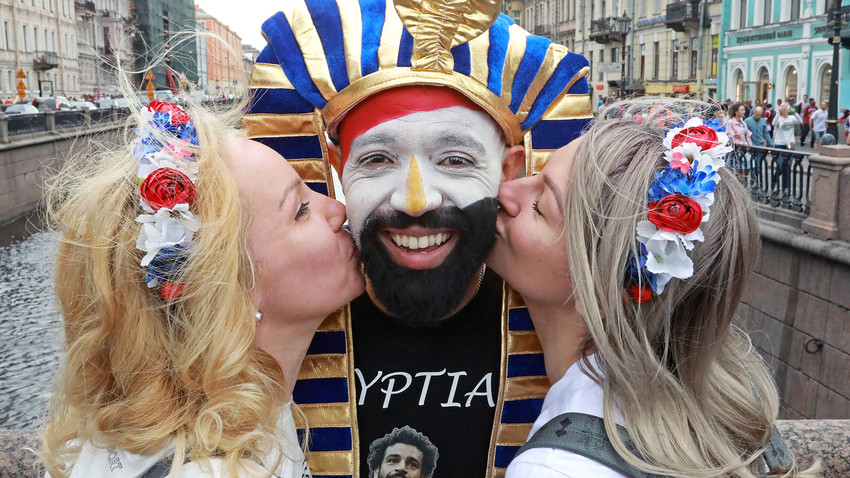 Egyptian and Russian football fans pose for a photo on Nevsky Avenue, St. Petersburg 