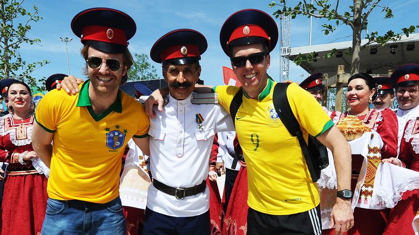 Brazil's fans pose for a photo with a Cossack upon arrival in Rostov-on-Don, Russia
