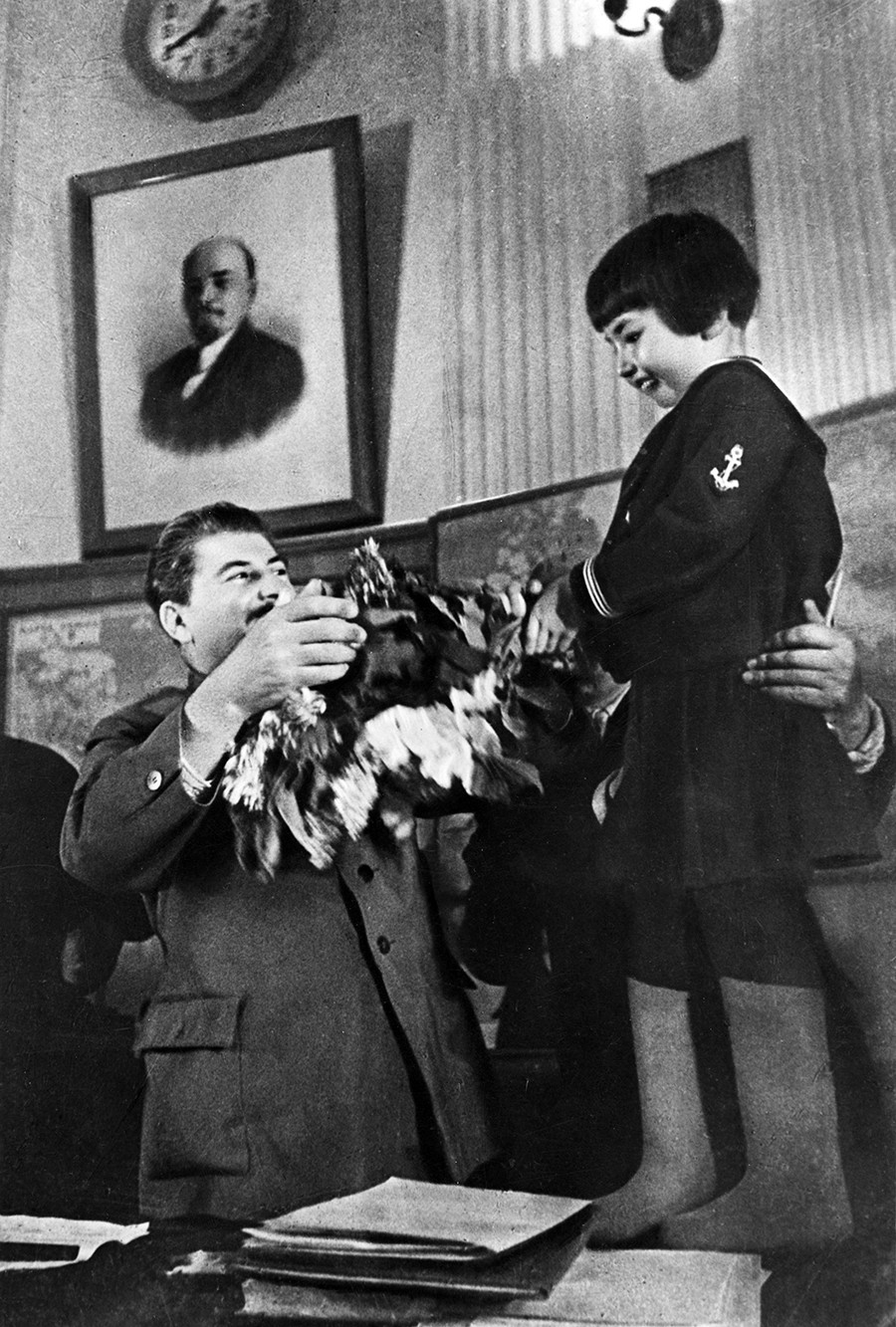 Joseph Stalin receiving a bouquet of flowers from Engelsina (Gelya) Markizova.