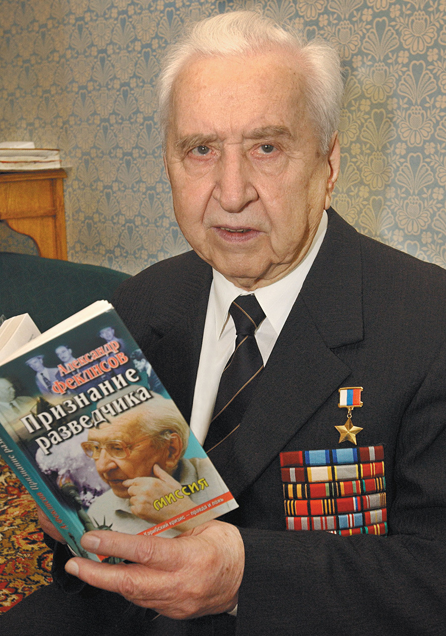 Alexander Feklisov, decades after the solution of the Cuban missile crisis, with a book of memoirs in his hands.