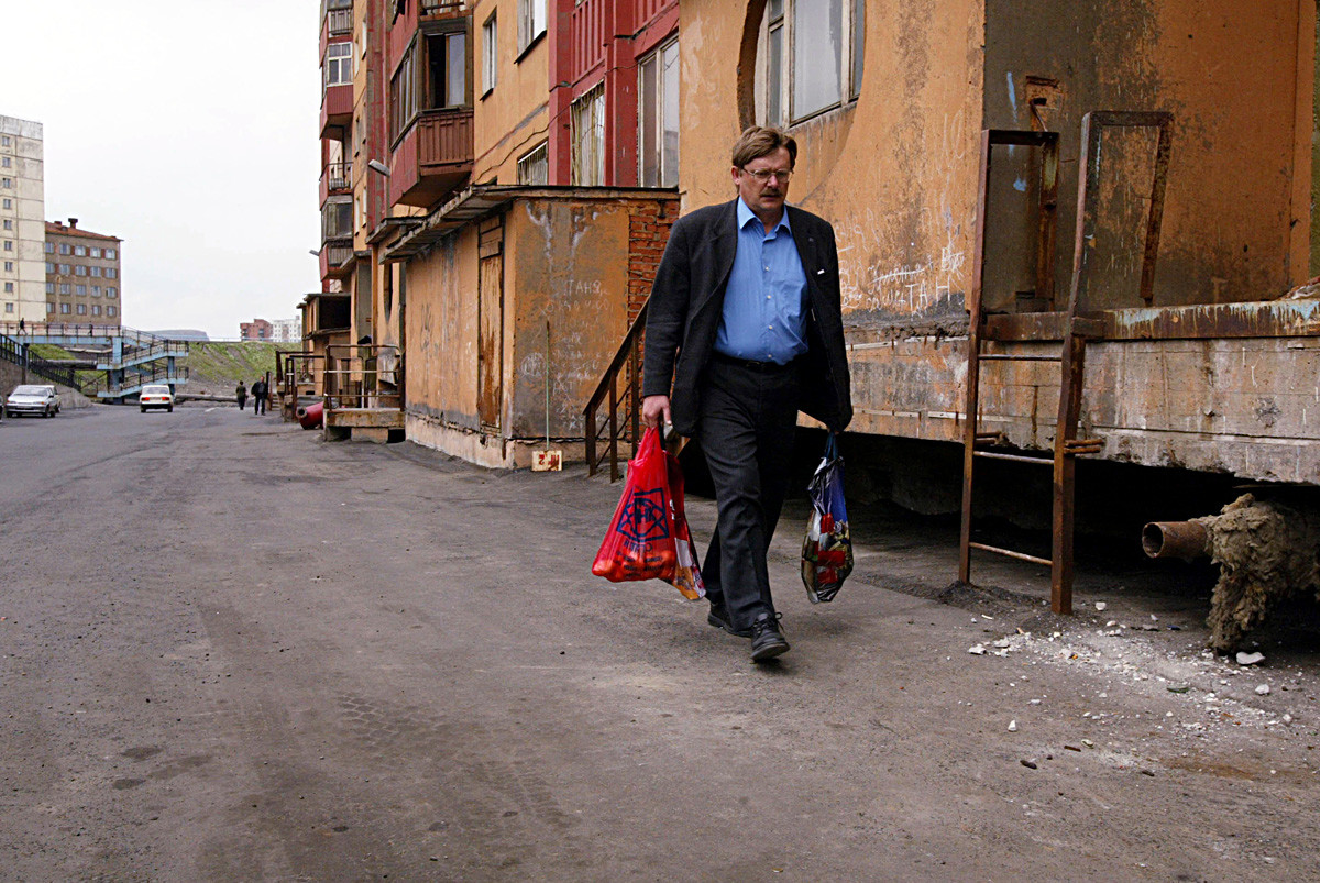 A man returns from the green market in Norilsk.