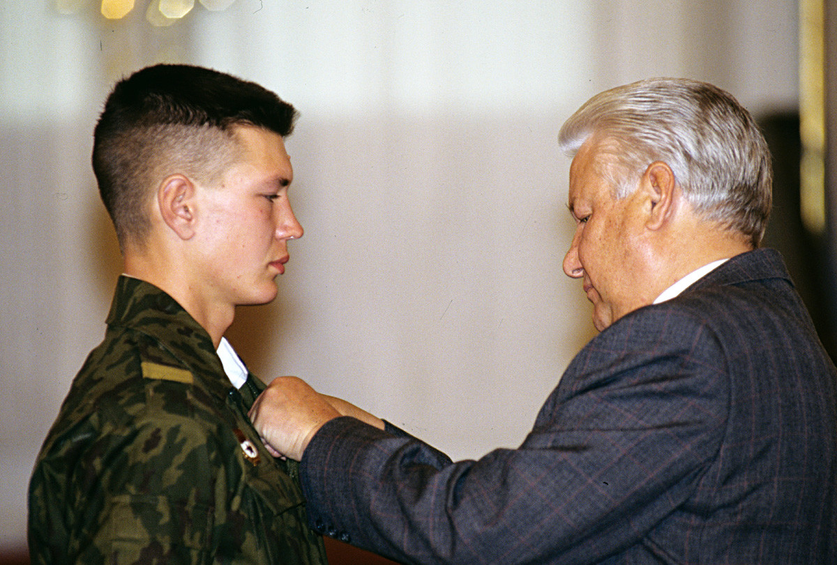 President Boris Yeltsin presenting the Order for Personal Courage to border troops private Vladimir Evgenyev for showing courage and heroism in performing the military duty at the Tajik-Afghan border. 