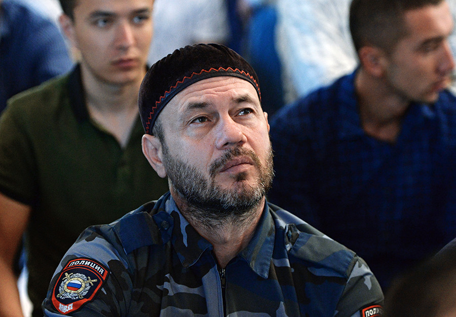 Seorang polisi muslim mendengarkan khotbah setelah salat Id di Masjid Jantung Chechnya, Grozny, Republik Chechnya, Rusia.