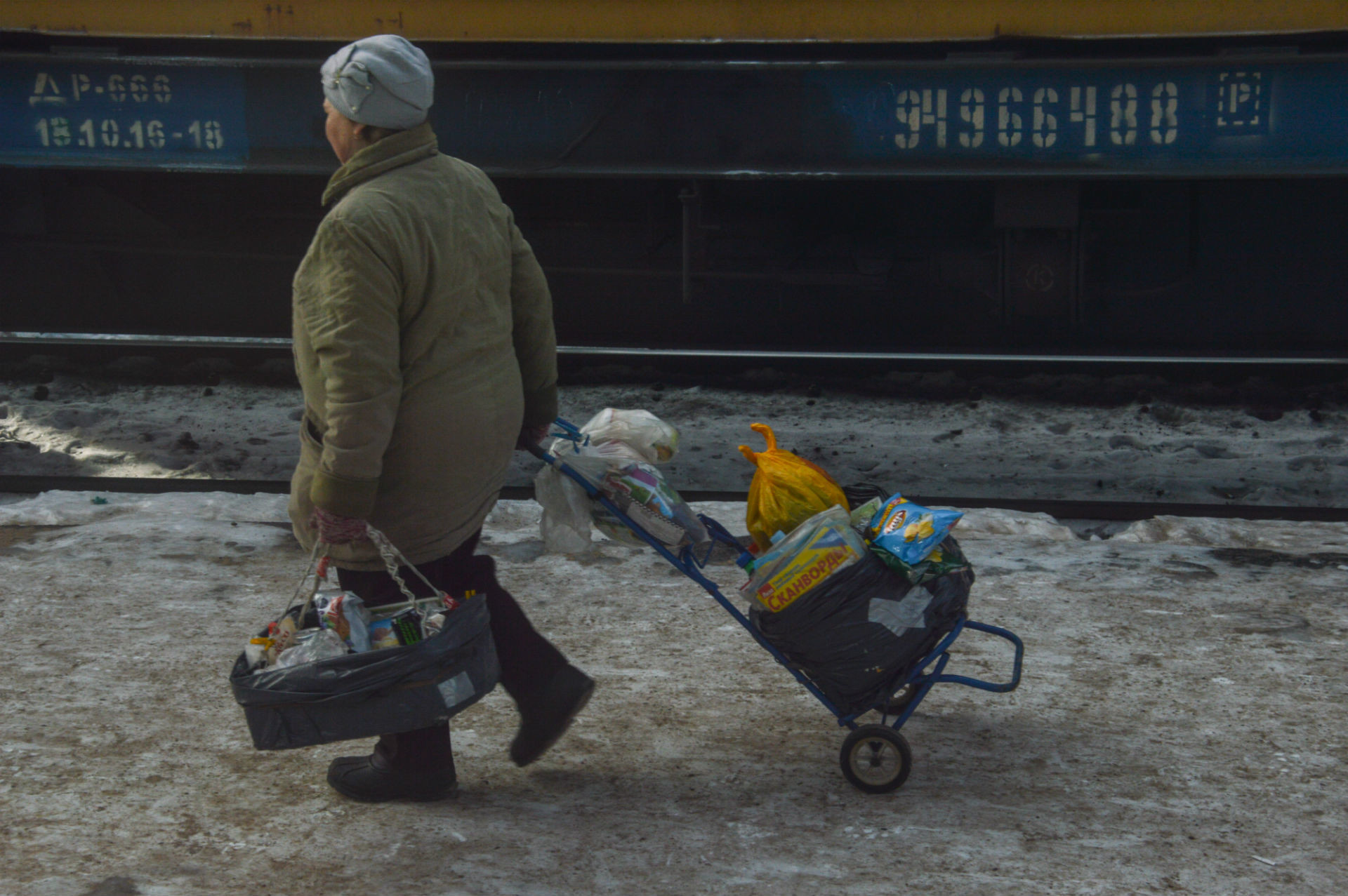 Babushkas get ready to sell their merchandise as they wait for passengers to arrive on the next train.