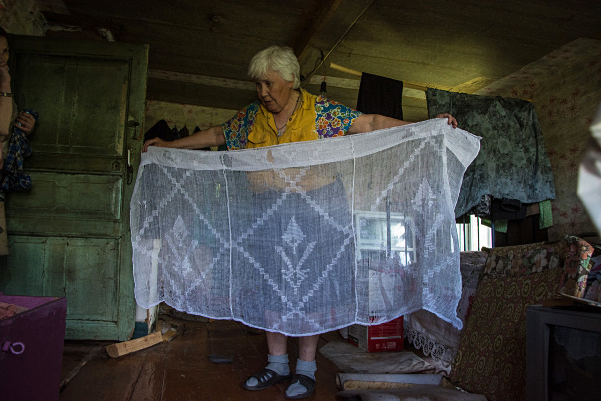 Lyuska shows drapes that her mother weaved from flax