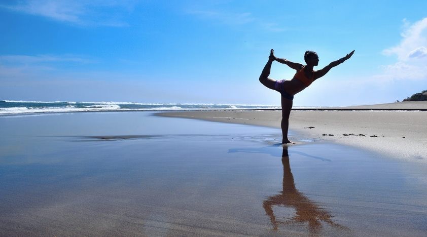 Kutepova practicing yoga on the beach in Bali