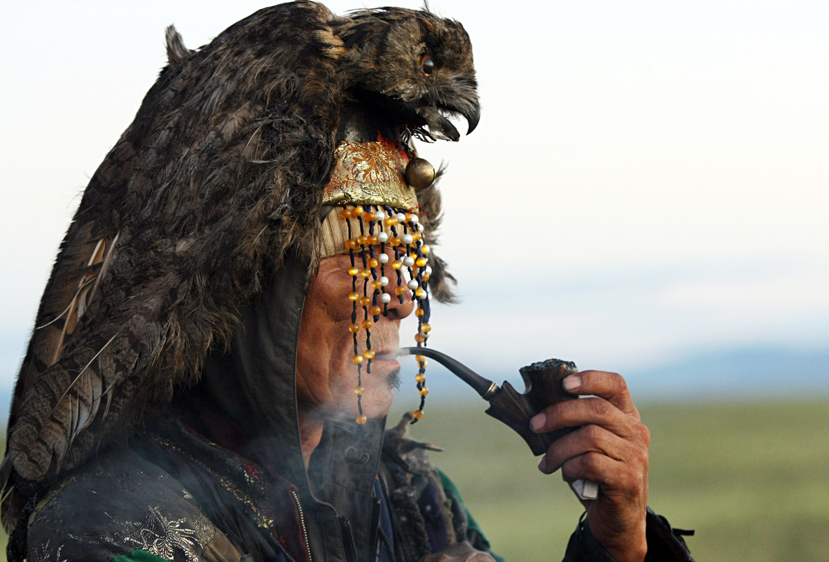 A Tuvan shaman awaits the sunrise during the grand shamanic ritual.