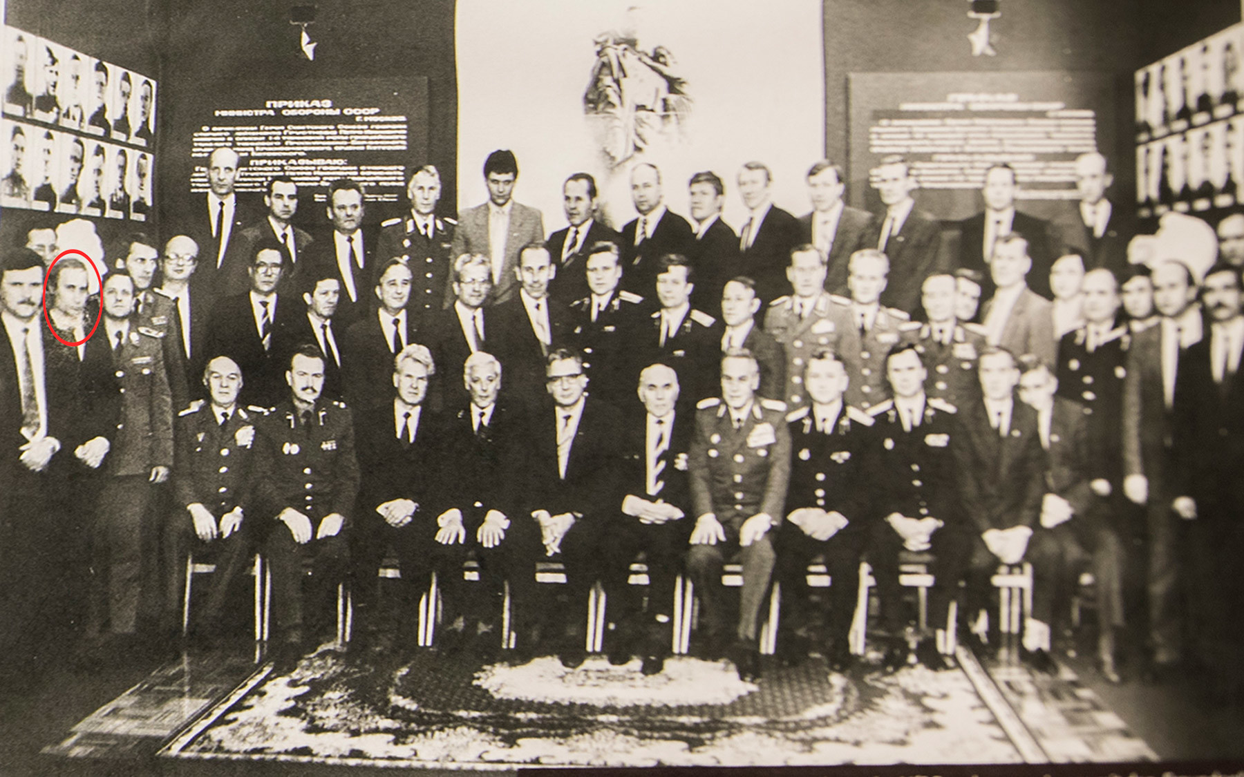 This picture shows a photo of Vladimir Putin as he stands in a group of senior Soviet and East German military and security officers at the regional office of the Stasi in Dresden.