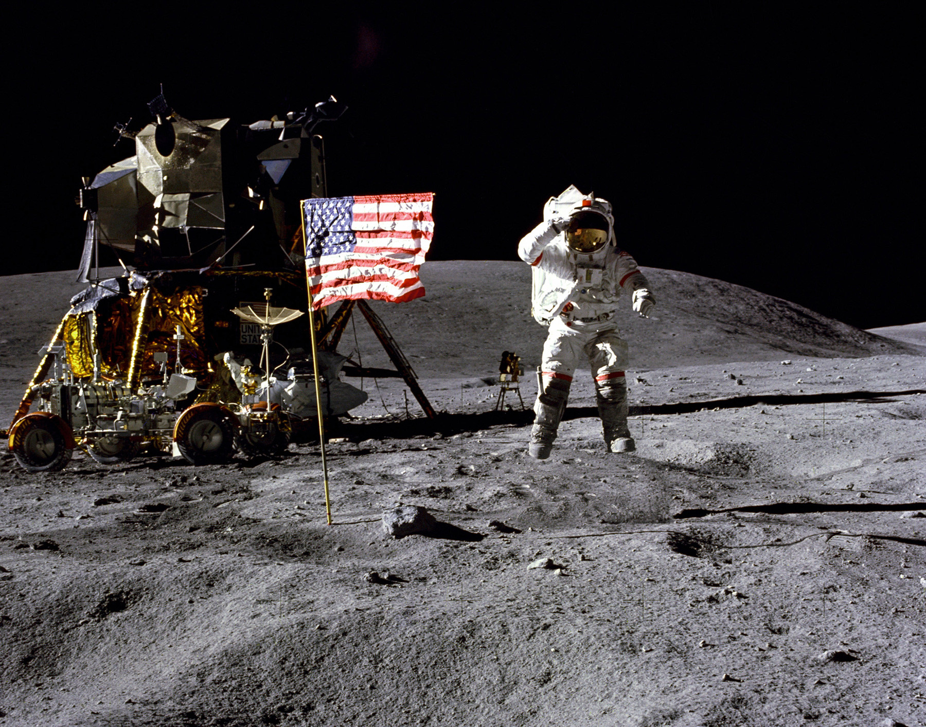 Astronaut John Young, lunar module pilot, walks on the surface of the Moon near the leg of the Lunar Module (LM) 'Eagle' during the Apollo 11 exravehicular activity.