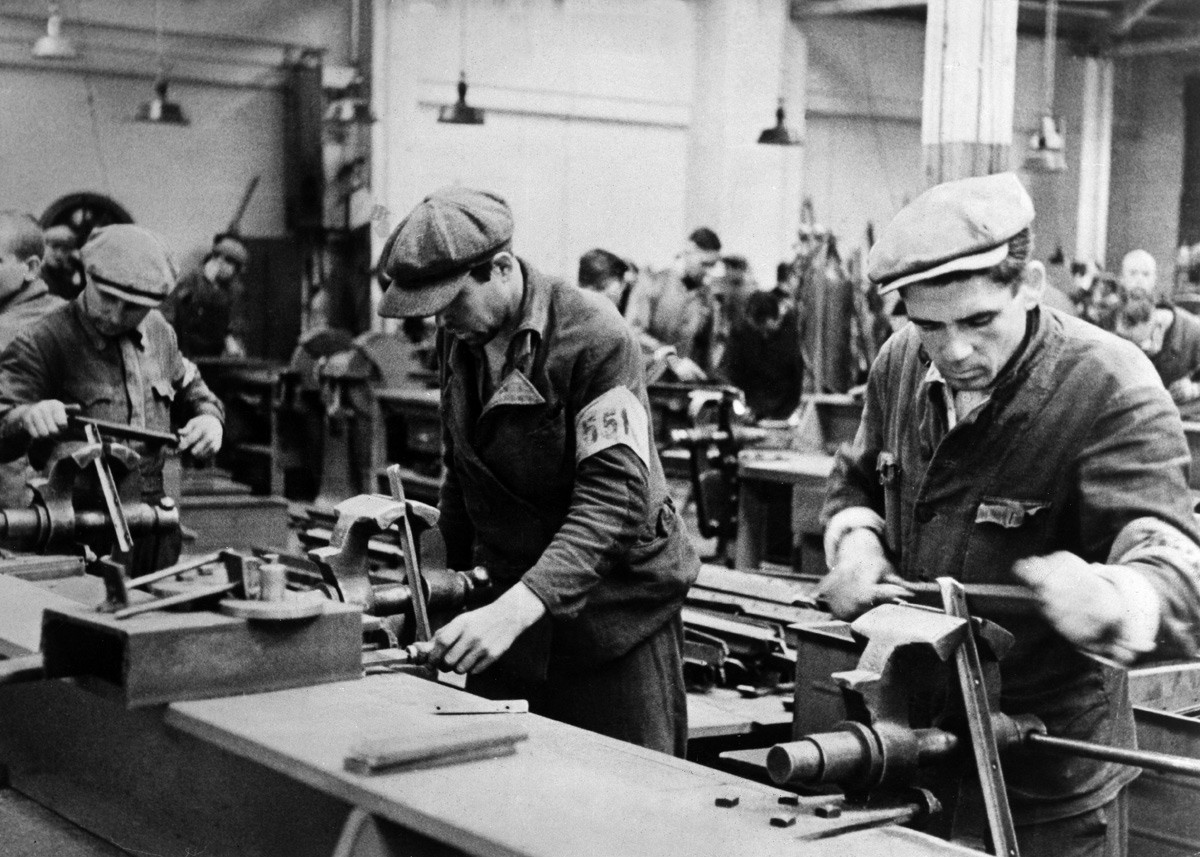 Ostarbeiter in an armaments factory in South Germany wearing armlets as markings.