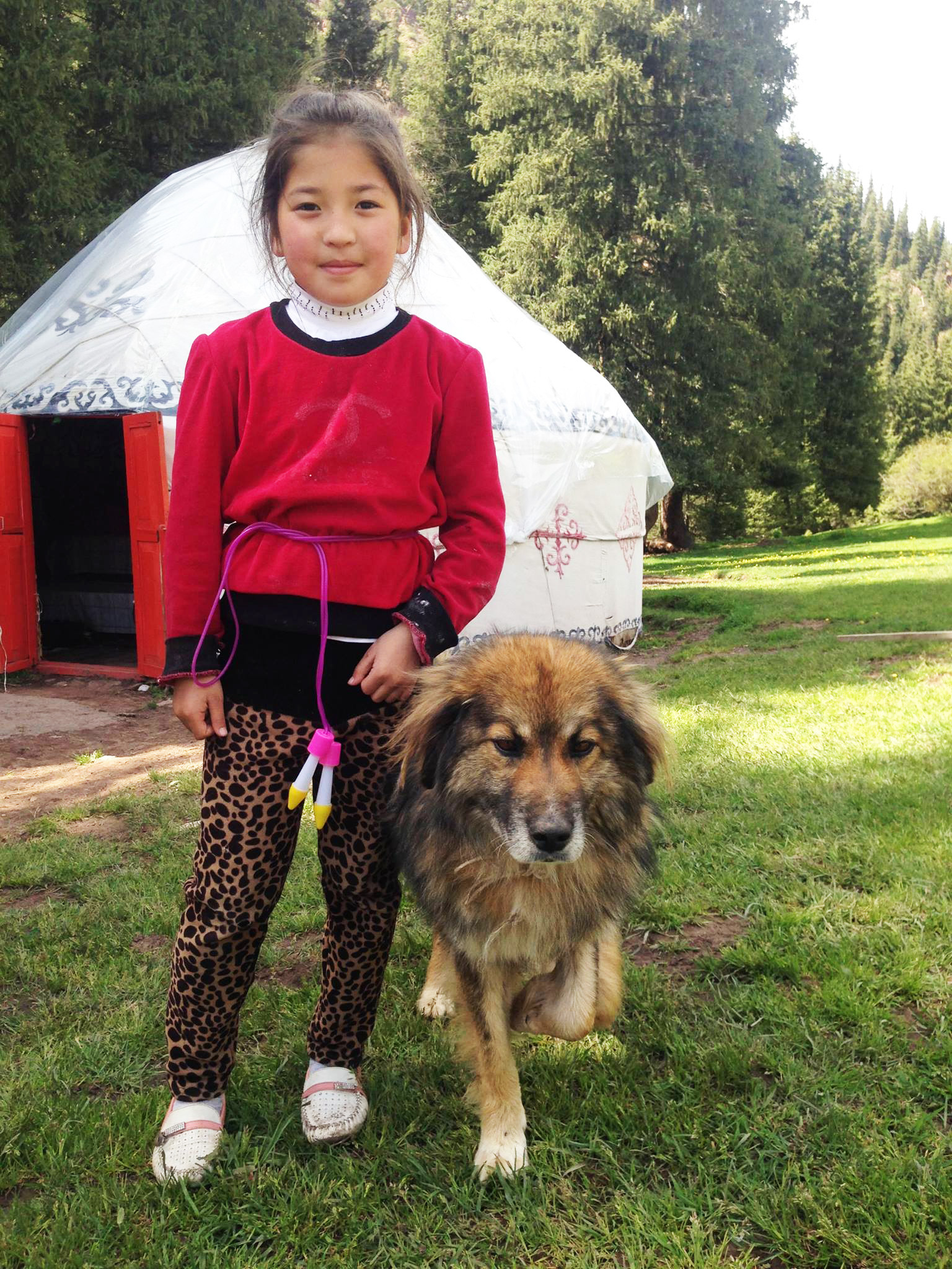 Kanykey, 8, is standing in front of her family's yurt in the mountains of Jeti Oguz, Kyrgyzstan. Her parents and grandparents have lived in Soviet-era flats for decades, but for several years now, they spend May-September in the mountains, just like their ancestors, before Soviet collectivization.