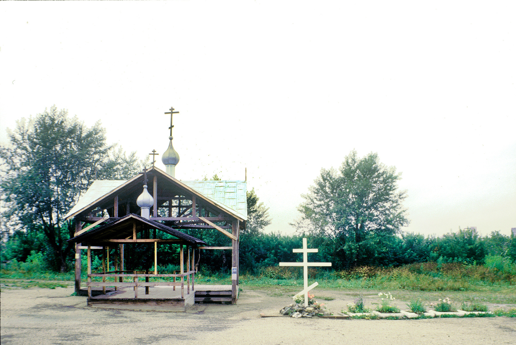 Cross & temporary chapel canopy on site of Ipatyev house (now site of Church of All Saints Resplendent in the Russian Land). August 25, 1999.