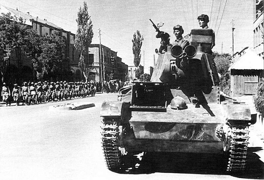 Sovjetski tankisti 6. oklepne divizije se peljejo po ulicah Tabriza v tanku T-26.