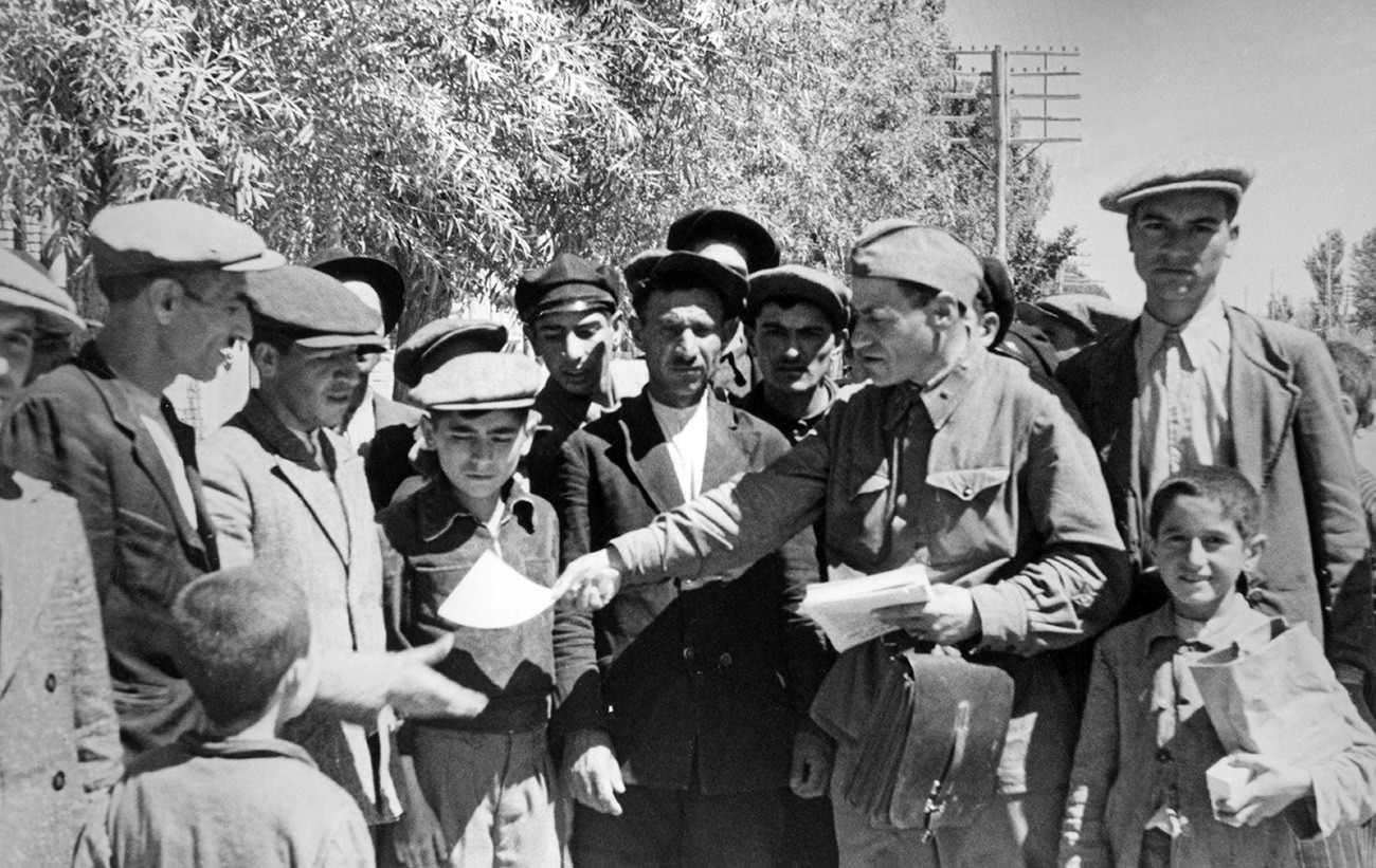 Иран. Табриз, 26. августа 1941. Совјетски политички руководилац дели агитационе листиће житељима града. Црвена армија је заузела град у склопу Иранске операције.
