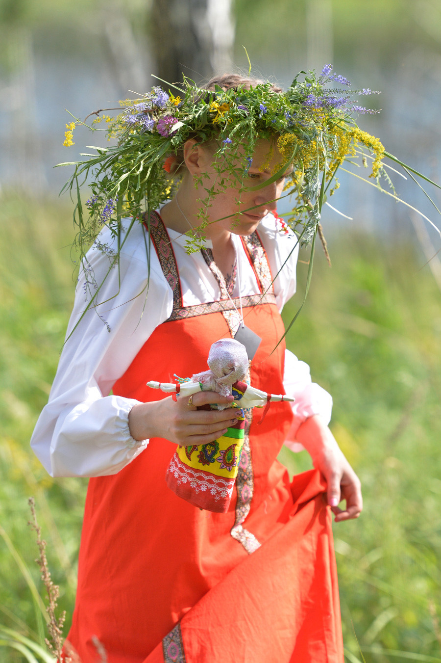 A young woman with a doll during the Ivan Kupala festival in the Chelyabinsk region.