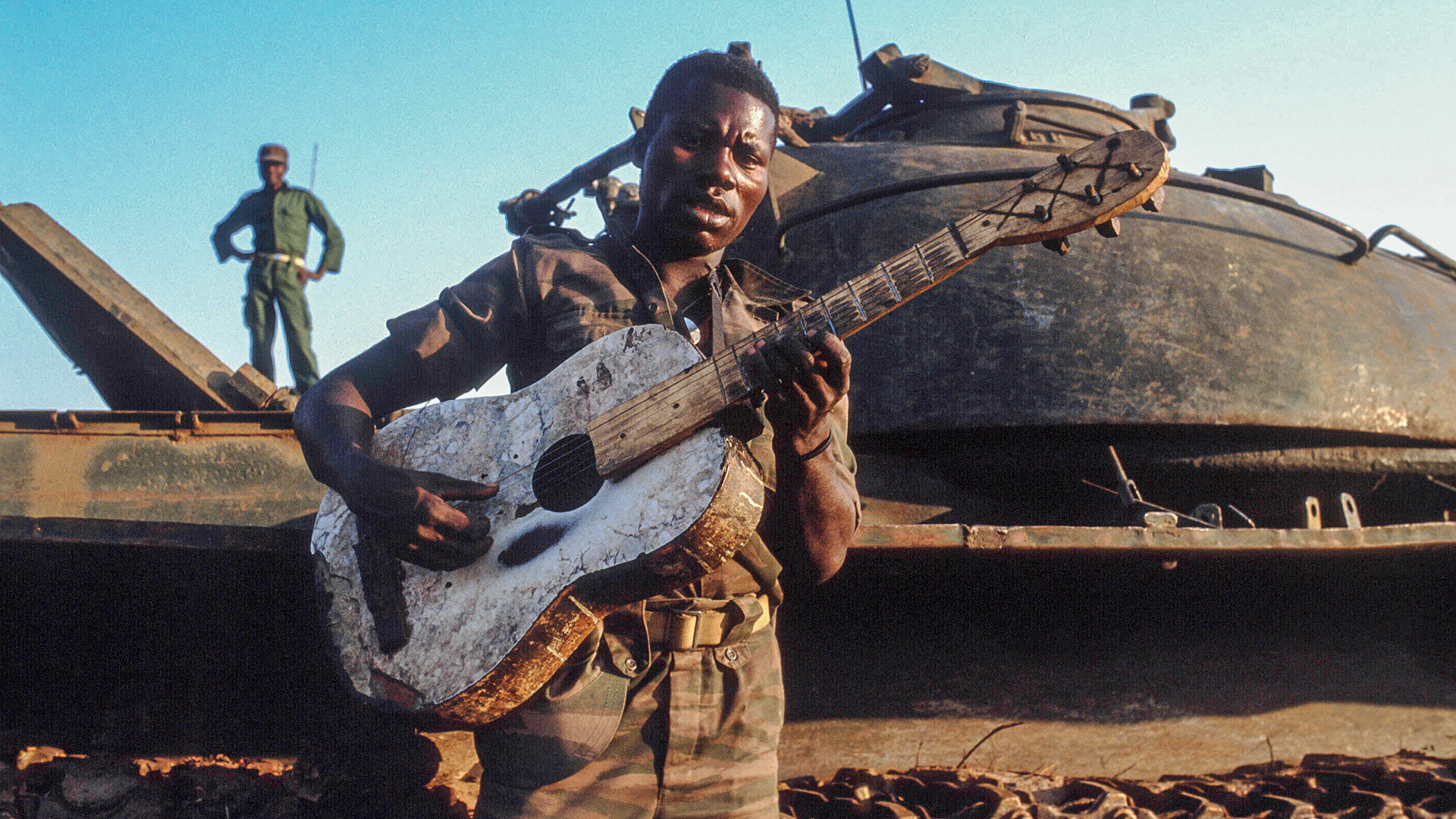 An African soldier against the background of a Soviet T-34 tank.