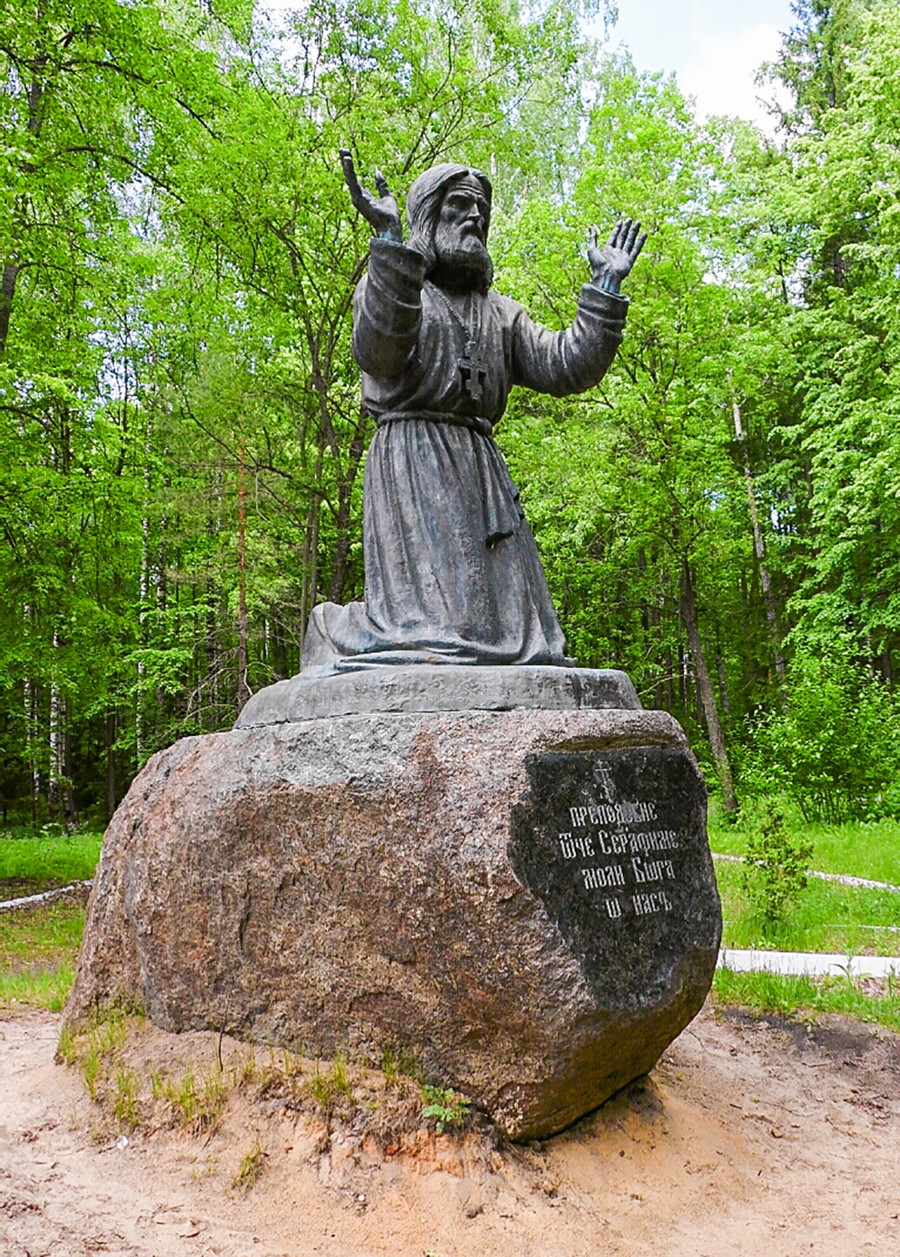 A monument to Saint Seraphim of Sarov standing on a stone