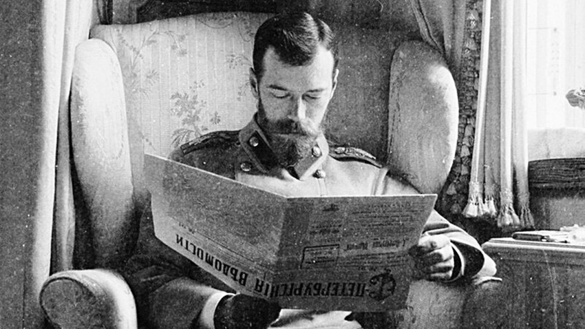 Nicholas II reading a newspaper in his palace at Tsarskoye Selo, 1902.