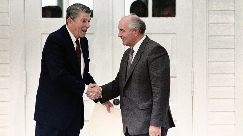 Concluding a morning meeting, President Ronald Reagan and Soviet General Secretary Mikhail Gorbachev shake hands. 