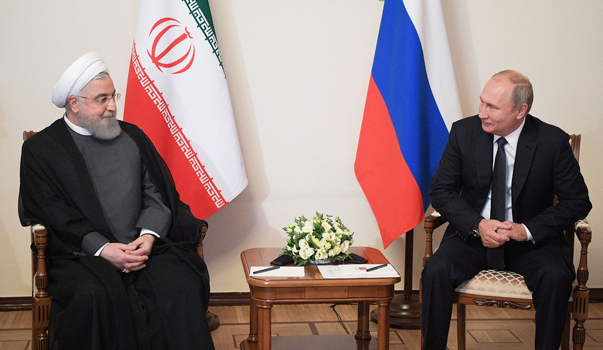 Russian President Vladimir Putin speaks with Iranian President Hassan Rouhani during a meeting of the Supreme Eurasian Economic Council in Yerevan on October 1, 2019.