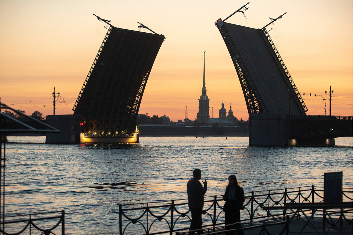 Dvortsovy (Palace) Bridge across the Neva River with the Fortress of St. Peter and St. Paul in the distance, at dawn.