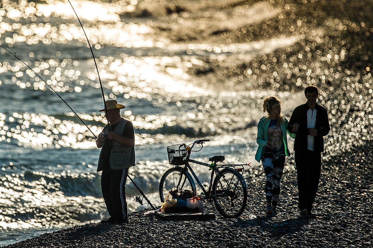 A fisherman on the Olympic Embankment in Adler. 