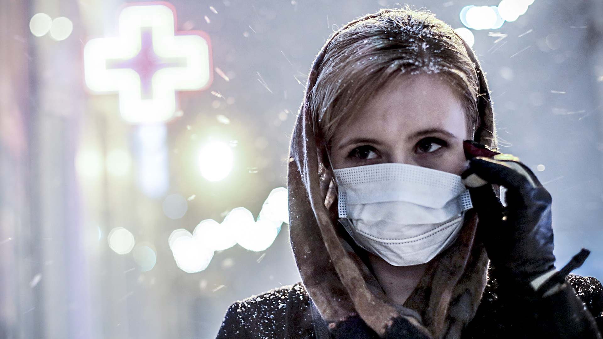 Russia. Novosibirsk. January 28. A girl in a medical mask on one of the streets of the city. 