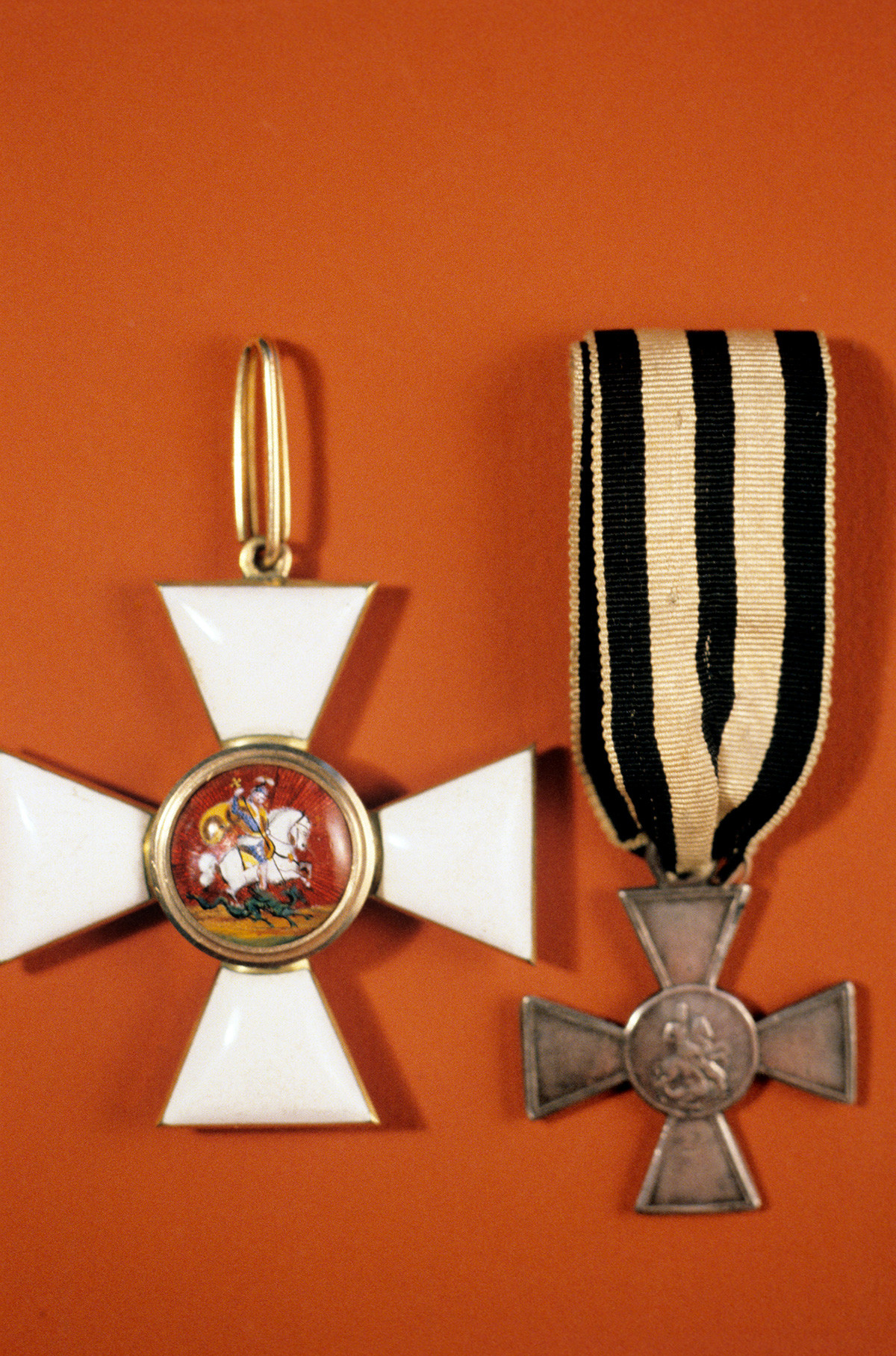 The Cross (badge) (L) of the Order of St. George, and the iron Cross of St. George (R), decoration of the Order meant for soldiers