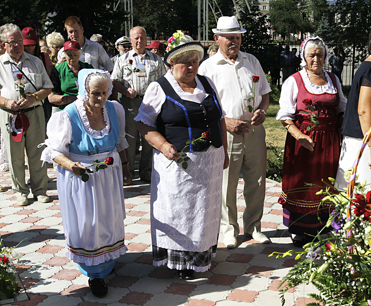 July 19, 2013, Saratov region, Russia. The 250th-anniversary celebrations of the publication of Manifesto of Empress Catherine II 'On inviting foreign settlers'. Placing the flowers at the monument to 'Russian Germans who were victims of repression in the USSR'.