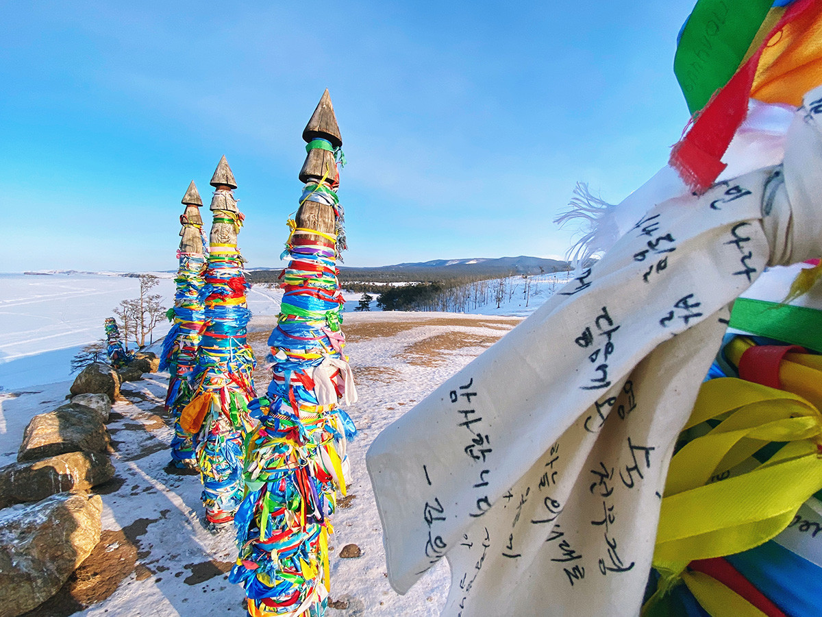 
Olkhon Island as well as other local rocks are considered sacred places among buddhists and shamans. Pictured: Khata, ceremonial scarfs in Buddhism, on Shamanka rock.