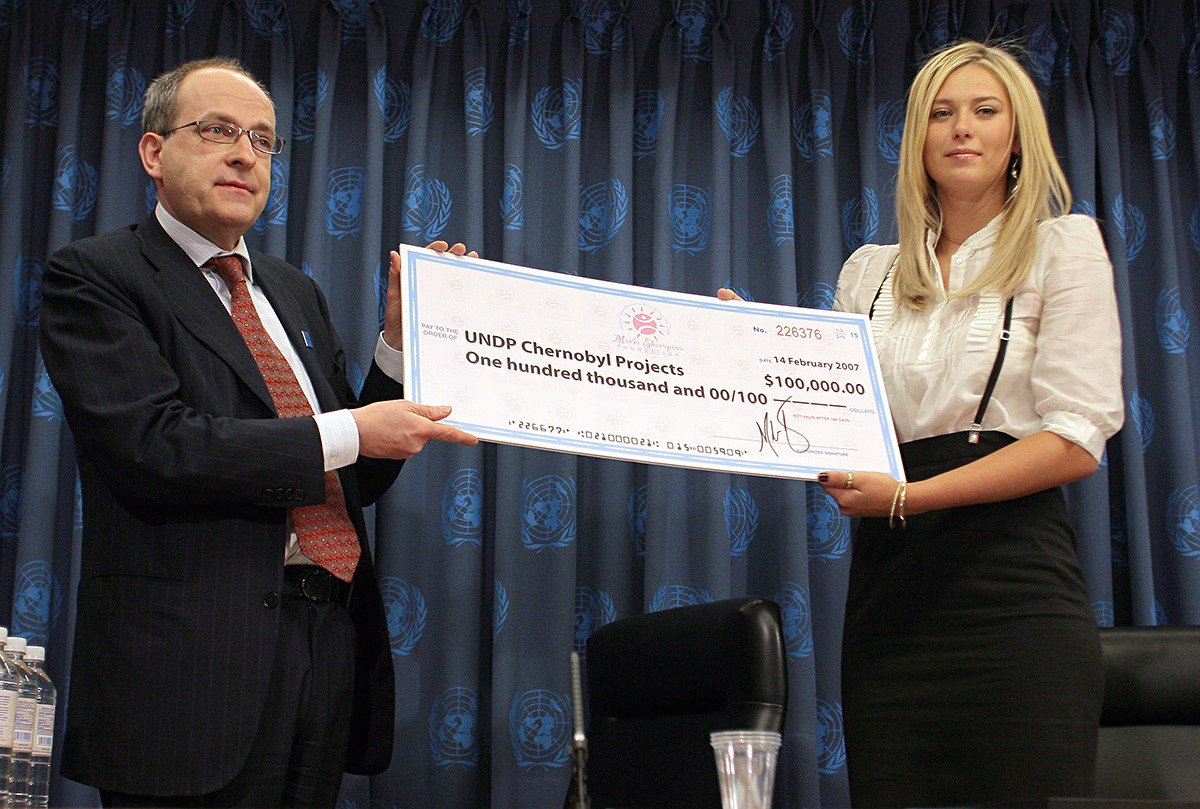 Ad Melkert, pomožni administrator UNDP prejema ček od Marije Šarapove med tiskovno konferenco, na kateri je bila ruska športnica razglašena za ambasadorko dobre volje Združenih narodov, 14. februarja 2017.
