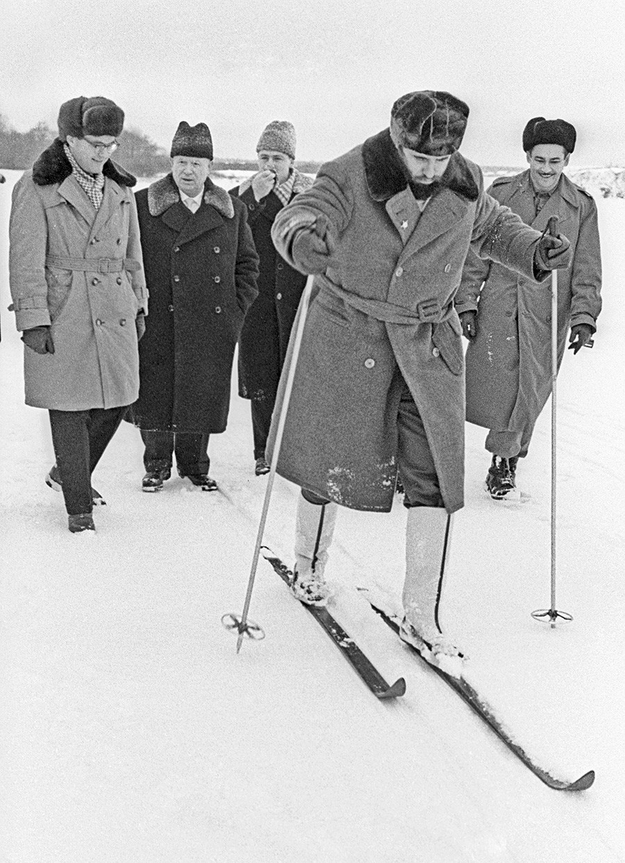 Castro (front) trying on skis, with Khrushev (second from left) looking on in amusement, Russia, 1964