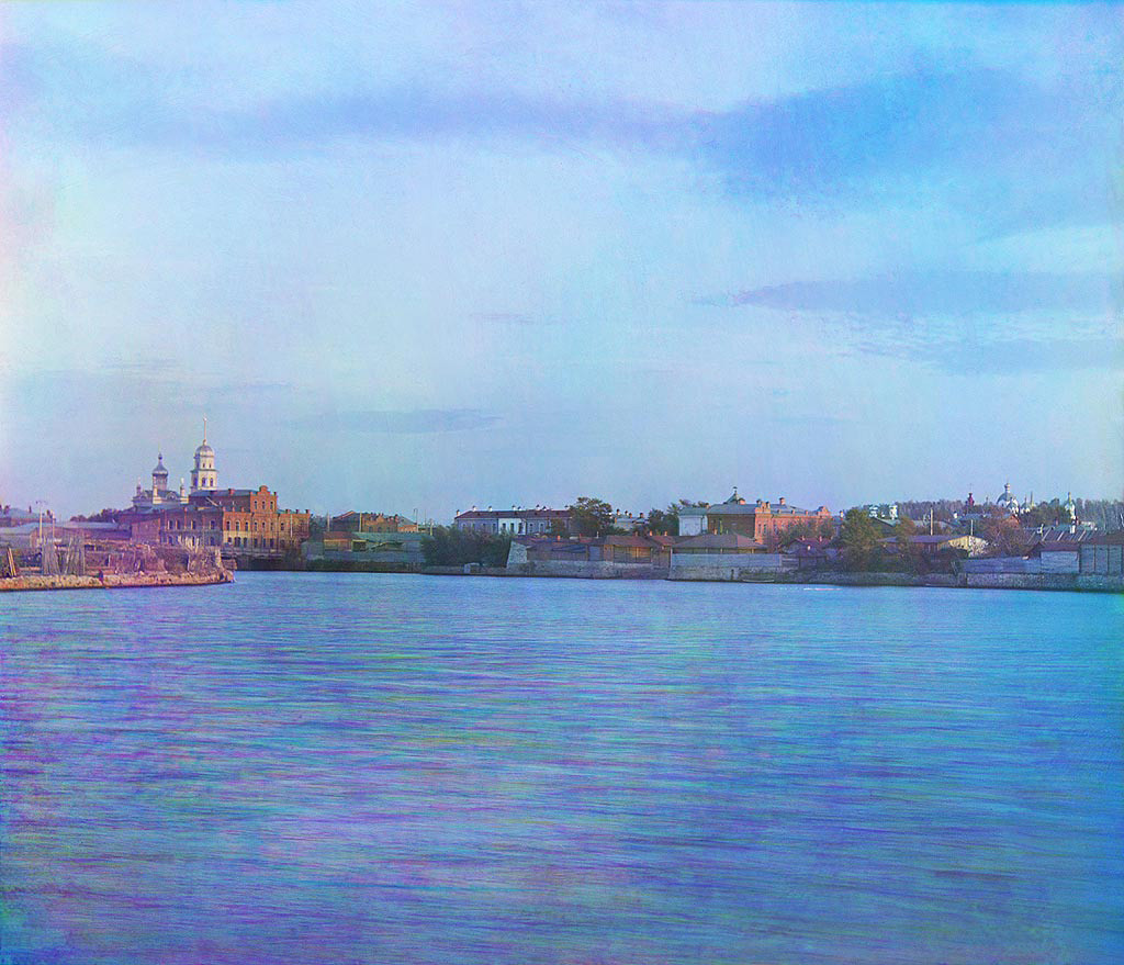 View of Chelyabinsk down the Miass River. Visible on far side are brick commercial buildings with Cathedral of Nativity of Christ (left) and Convent of the Hodegetria Icon of the Virgin (far right) - both demolished in the Soviet period. Late summer 1909.