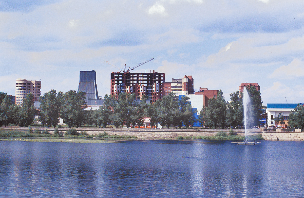 View across Miass River toward Kirov (formerly Ufa) Street. July 13, 2003.   