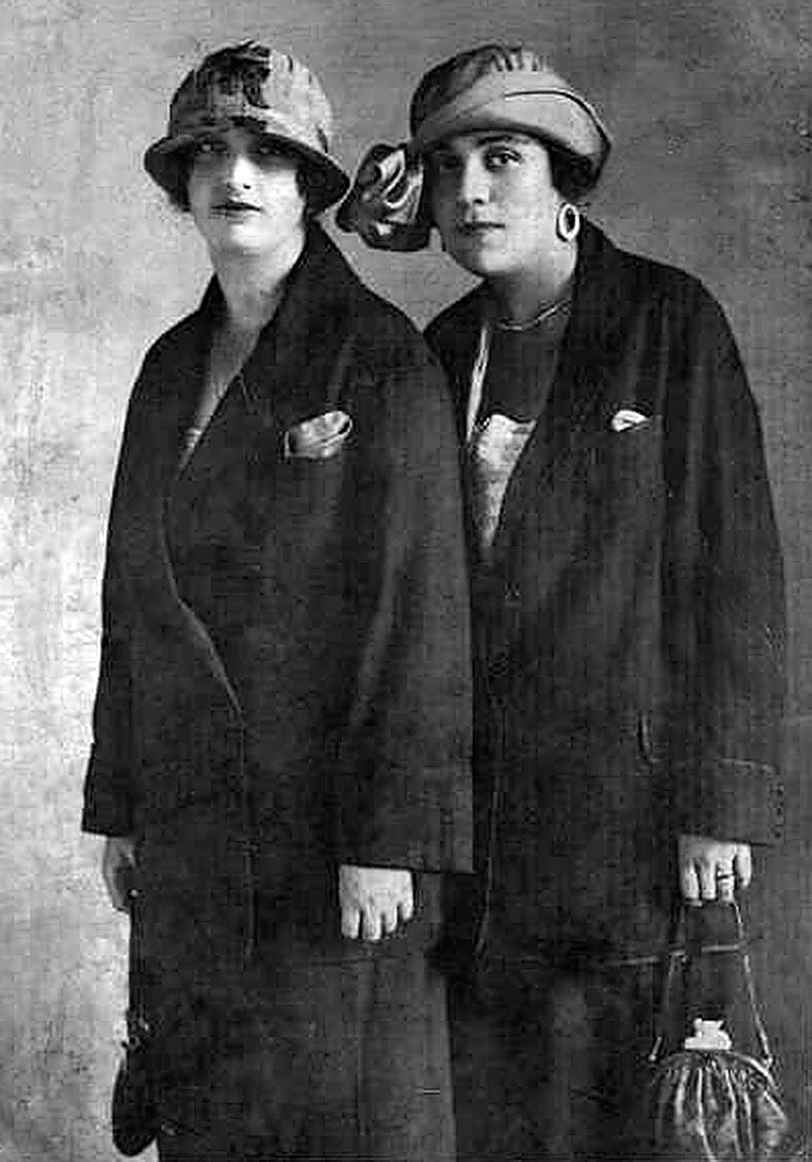 Two ladies posing in hats