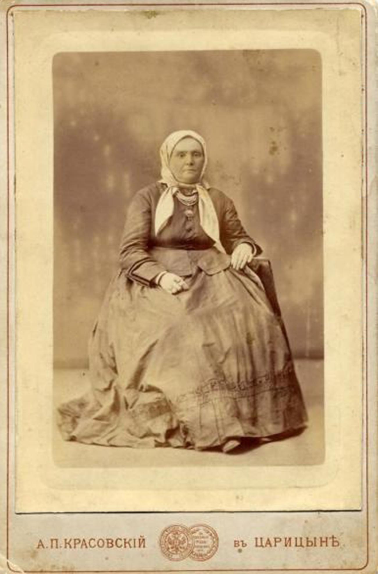 An old woman posing in a headscarf, 1870s 
