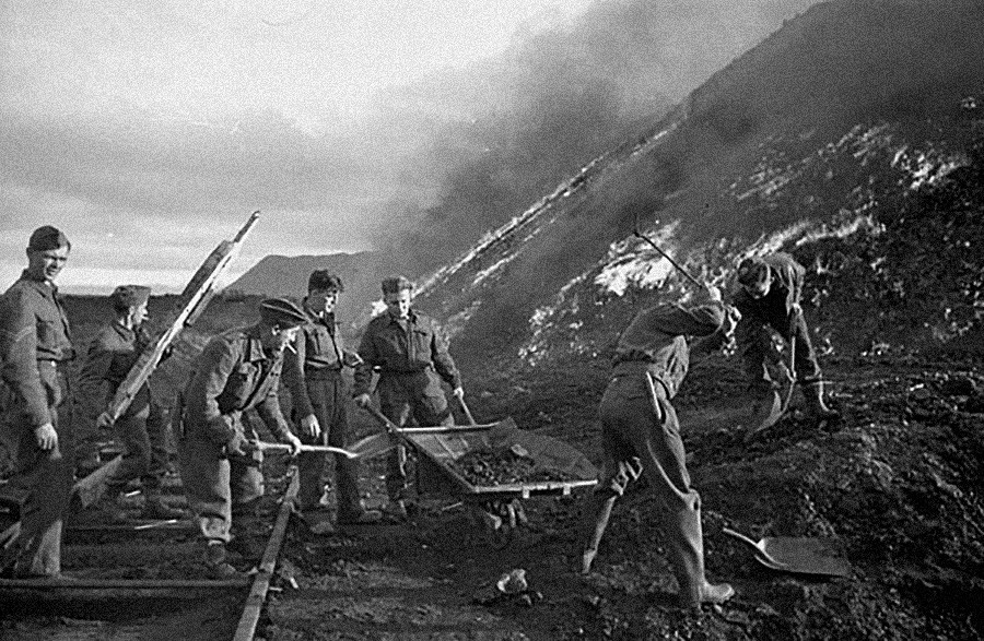 Sappers of the 3rd Field Company, Royal Canadian Engineers, burning coal piles.