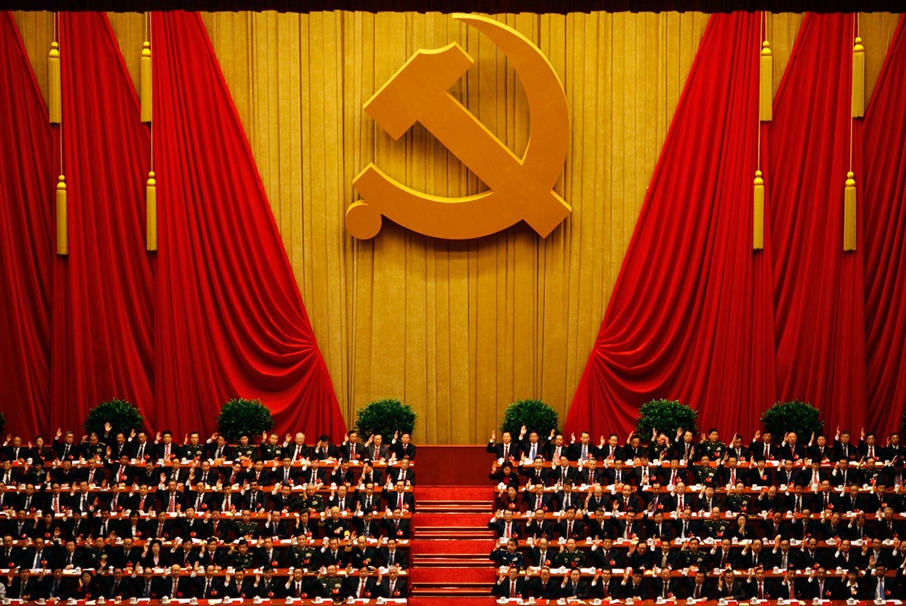 A general view shows delegates raising their hands as they take a vote at the closing session of the 18th National Congress of the Communist Party of China at the Great Hall of the People in Beijing.