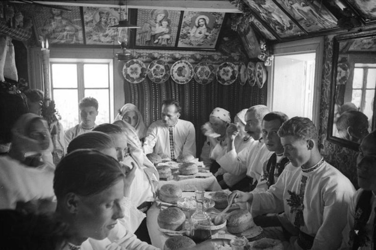 Village wedding. Feast in a hut, 1940  