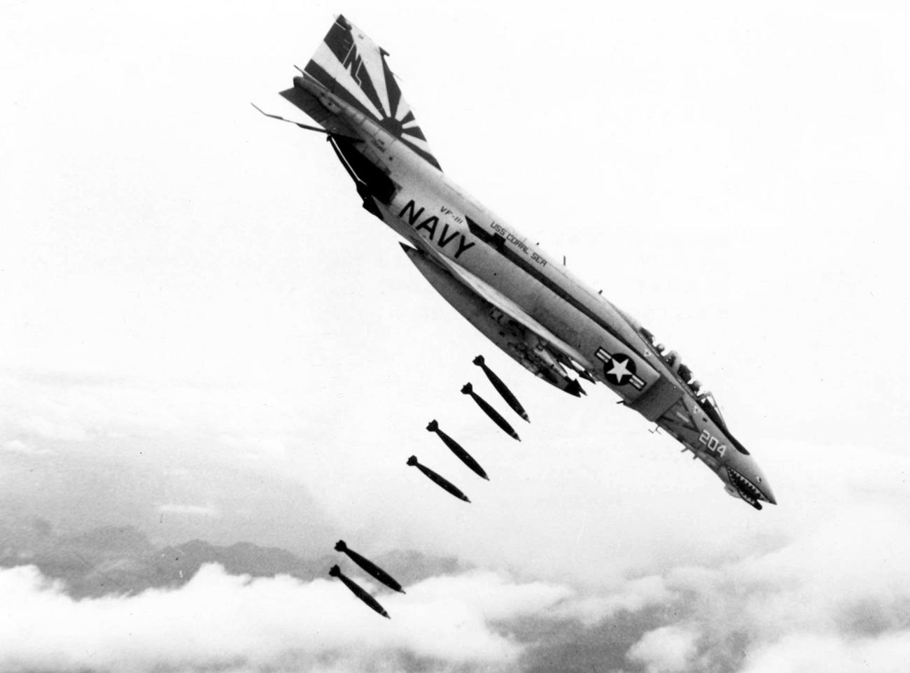 An F-4B Phantom II of Fighter Squadron VF-111 Sundowners drops 227 kg Mk 82 bombs over Vietnam during 1971.
